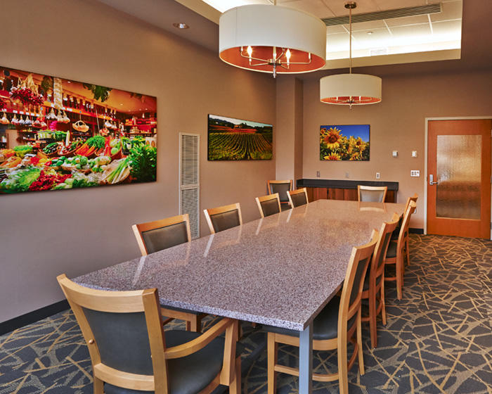 interior shot of Statler Executive Room; one large table in a private room with artwork hanging from the walls